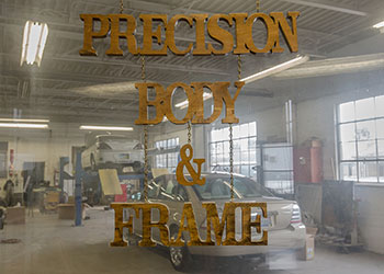 Precision Body & Frame interior sign with garage view
